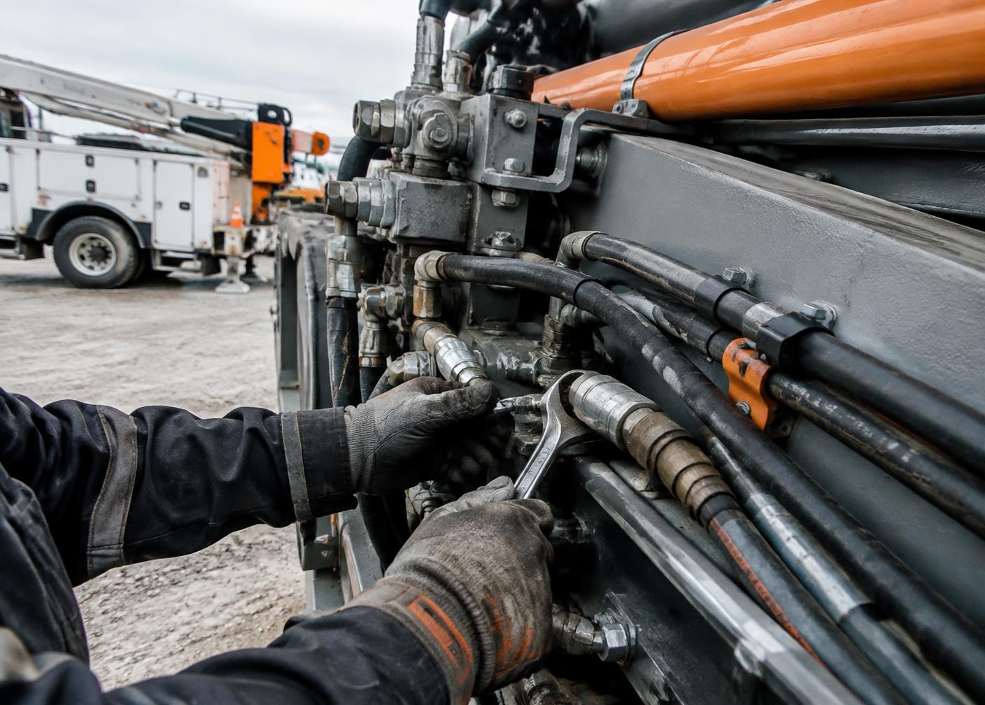 Mechanic repairing hydraulic lines